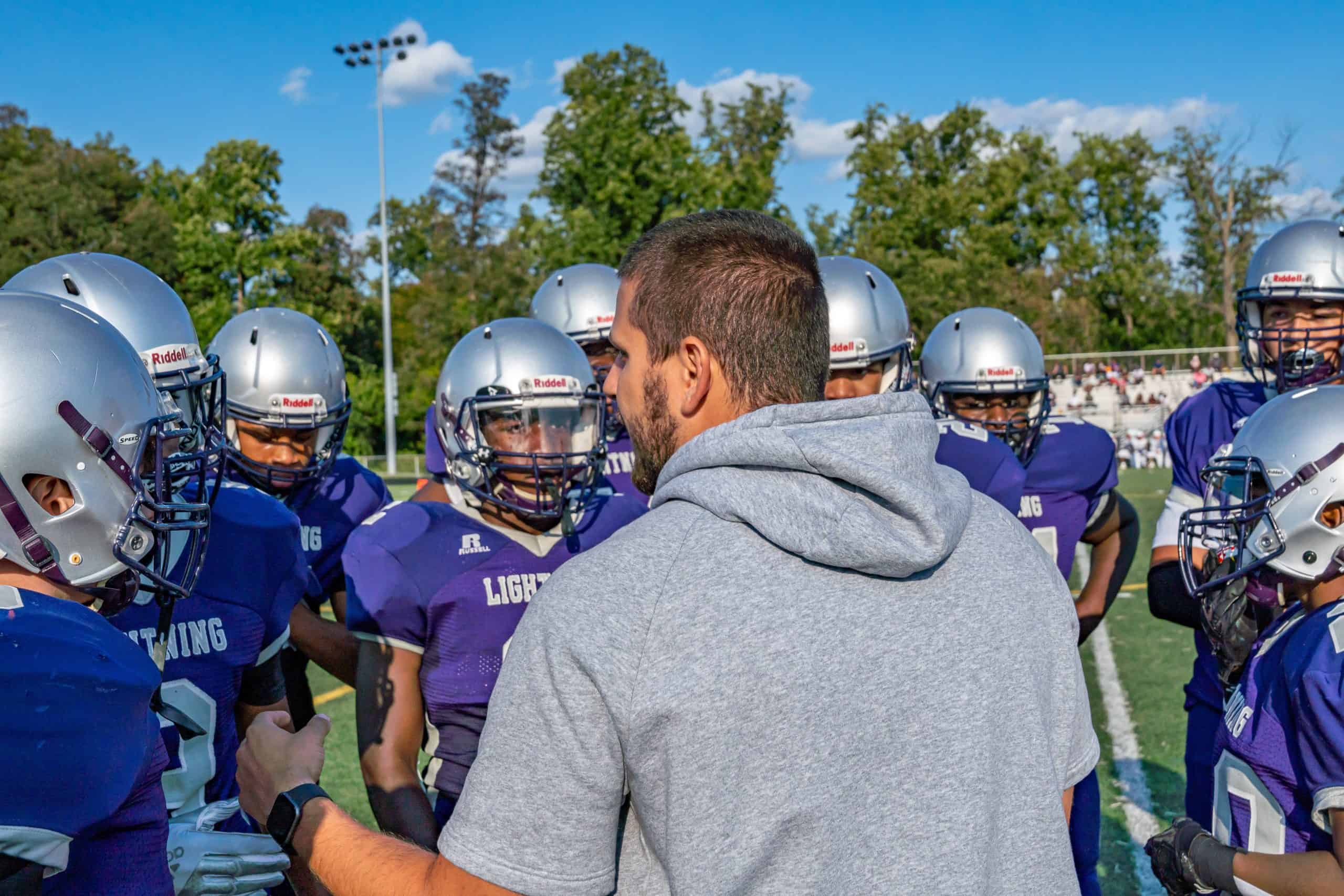 Football Coach talking to Athletes
